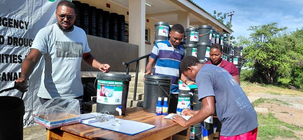 Community members registering for water supply distribution in Zambia