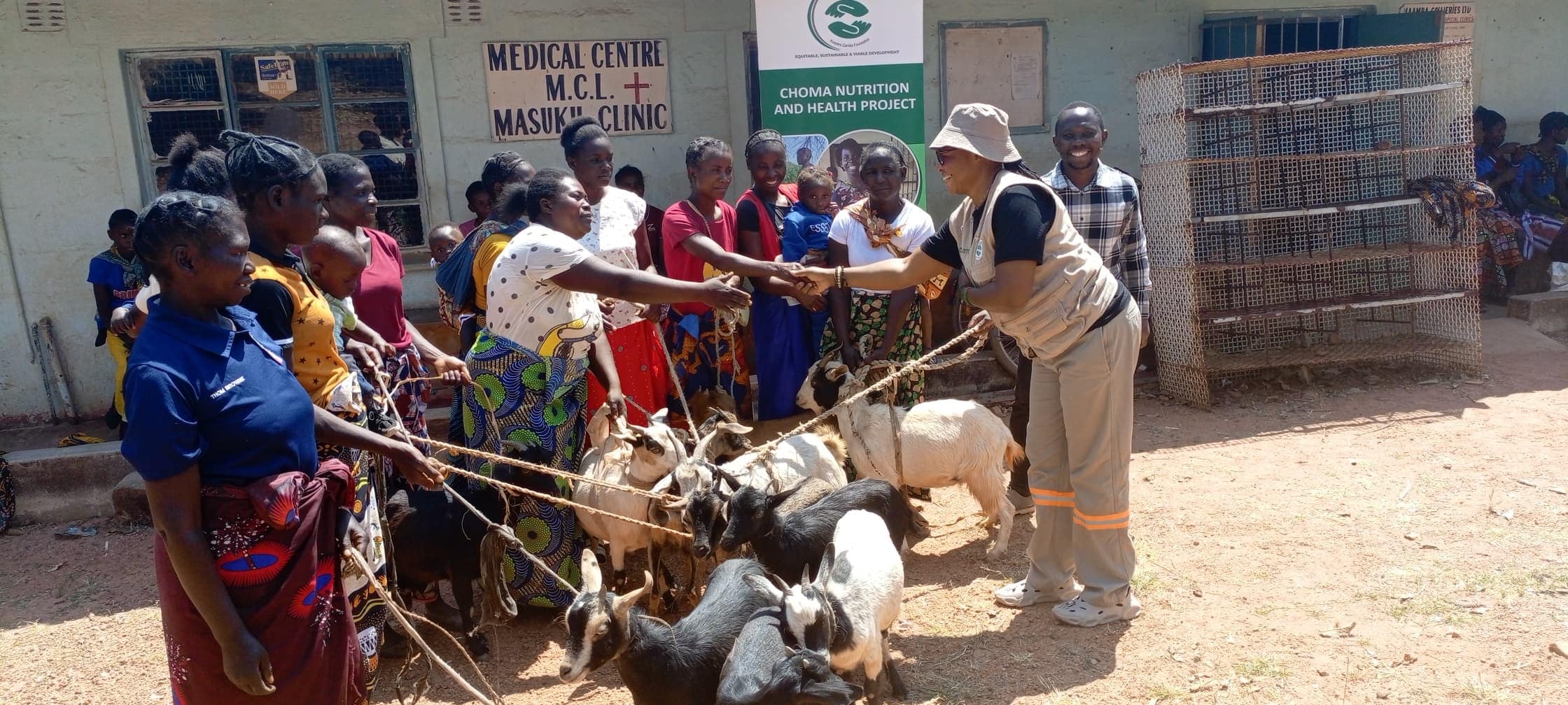 Women receiving goats during a livelihood support activity at a health facility