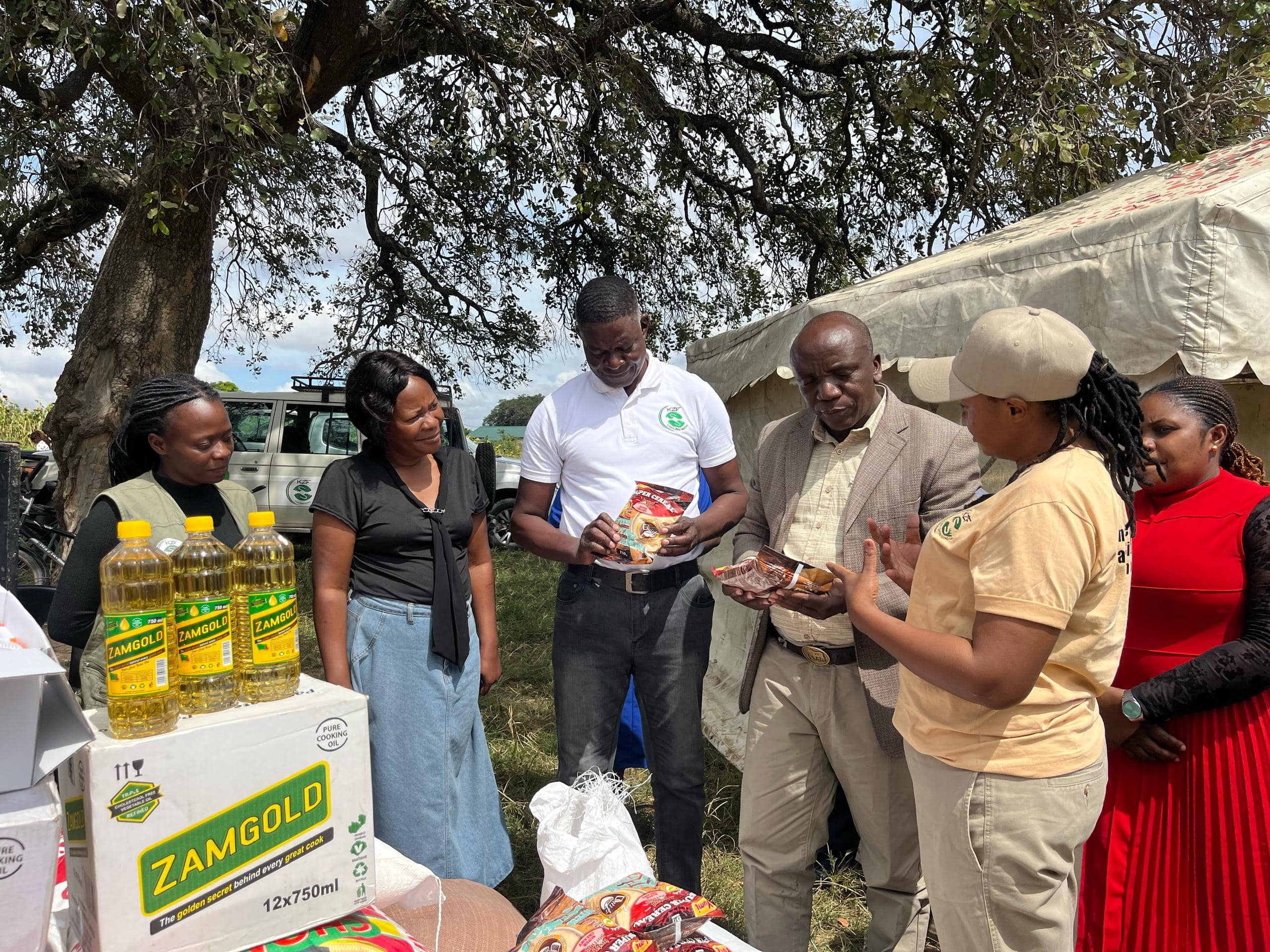 District officials and KZF team reviewing food and household supplies during a community distribution activity