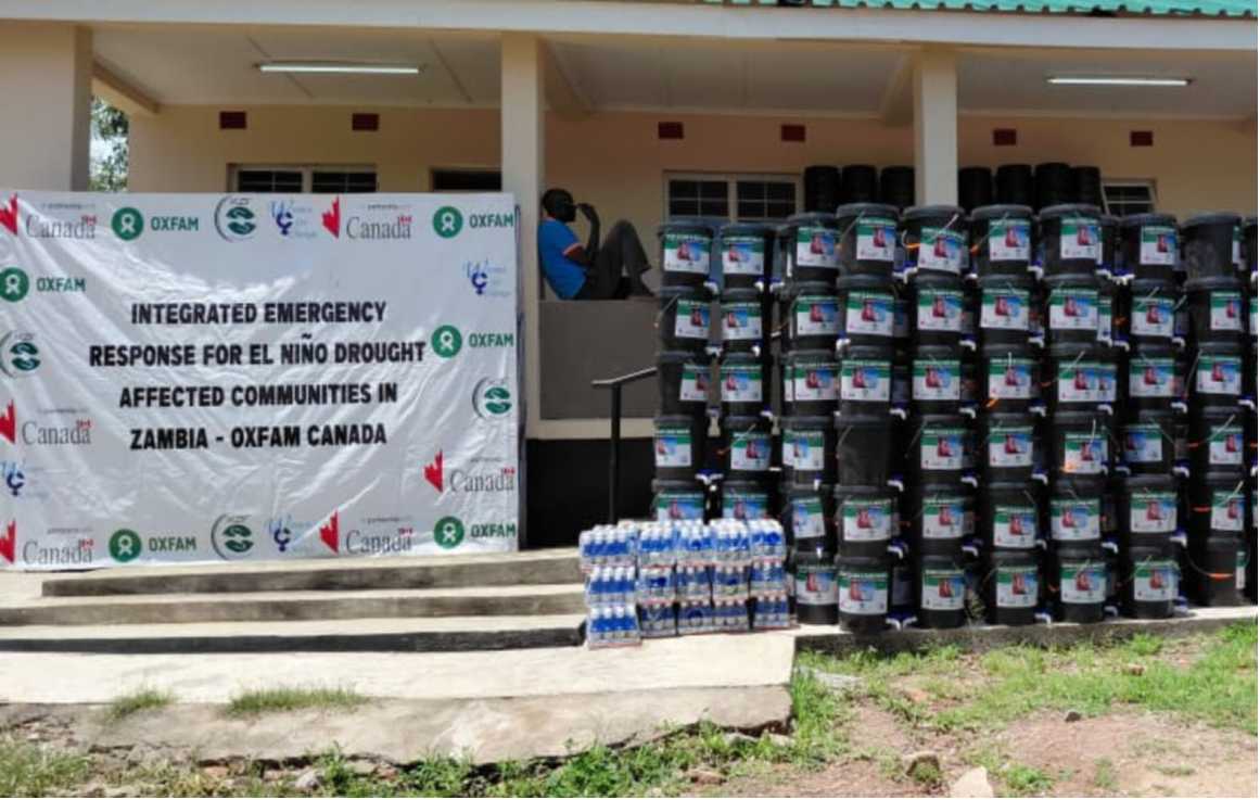 Stacks of water buckets and supplies for drought response in Zambia