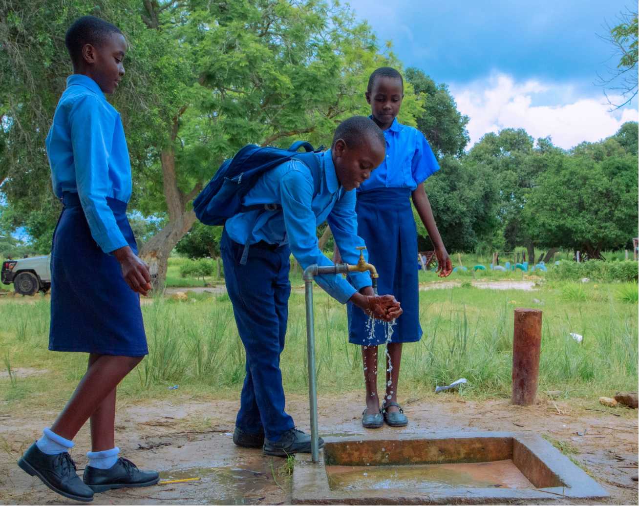 School children washing hands at a water point in Zambia